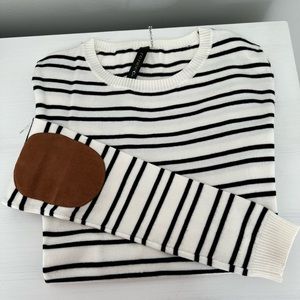 Crewneck B&W striped sweater with brown suede elbow patches. Like new condition!